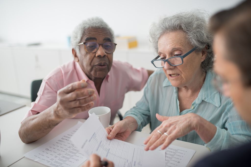 Health insurance consultation helping a couple plan for big medical bills